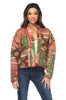 Woman wearing a patterned jacket and jeans on a white background